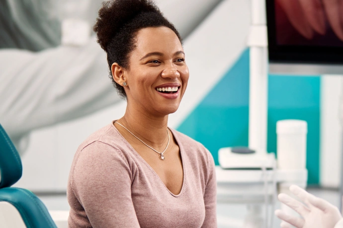 Smiling woman in dental office chair during consultation at Brown Road Dental