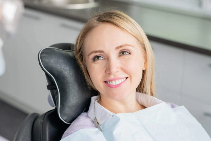 Woman smiling in dental chair at modern dental office clinic