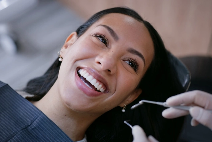 Woman smiling during dental examination at Brown Road Dental office